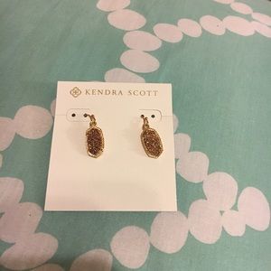 Rose gold Kendra Scott earrings.